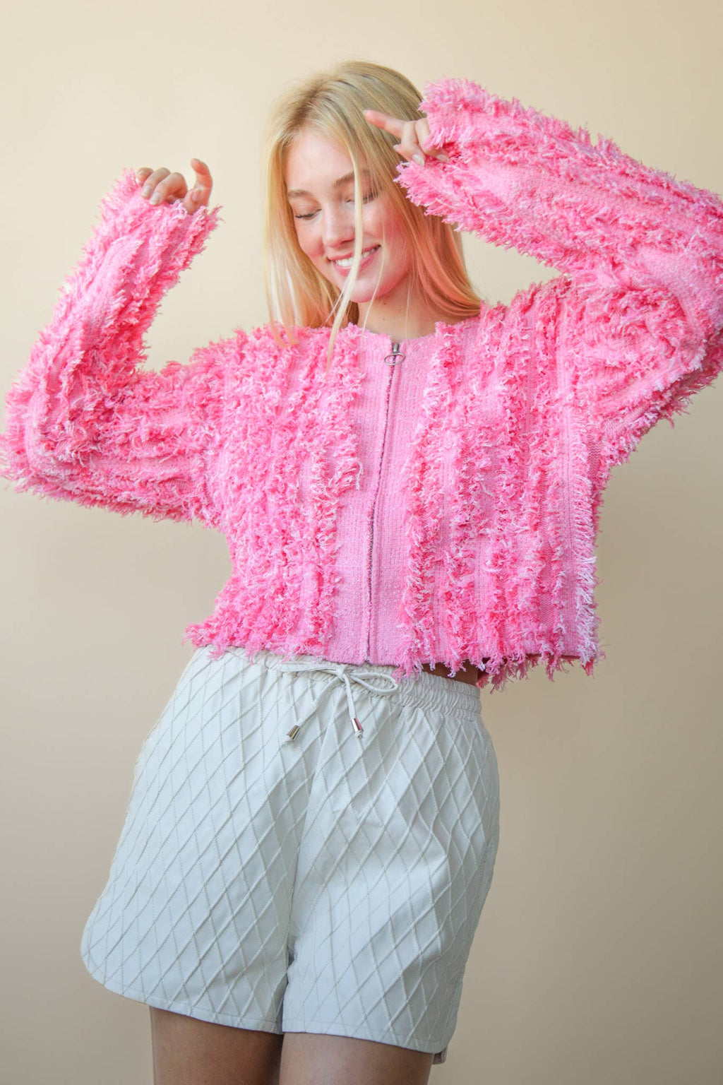 Bella’s pink textured zip sweater.